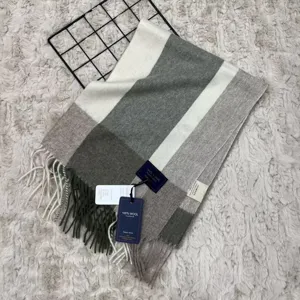 Detailed view of cozy wool plaid scarf texture, elegant fringe detail, and product tags.