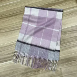 Detailed view of a cozy purple and white plaid wool scarf featuring fringe tassels.