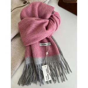 Cozy pink and grey color-blocked wool scarf with stylish fringe, warm winter accessory.
