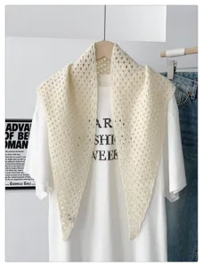 Detailed view of women's knitted hollow solid color triangular shawl, stylish sunscreen scarf.