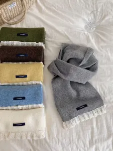 Detail view of Korean style knitted scarf with lace trim, solid color winter warm neckwear.