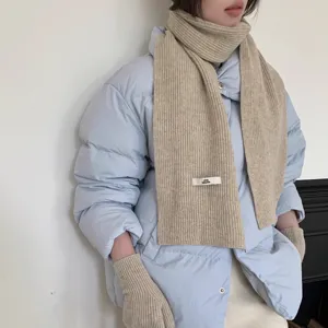 Detail view of cozy knit scarf and gloves set, warm winter fashion accessory for cold days.