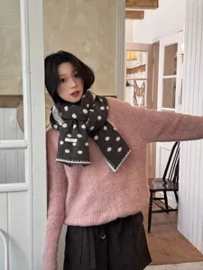 Cozy winter knit polka dot scarf with stitched edges, stylish warm accessory for women.