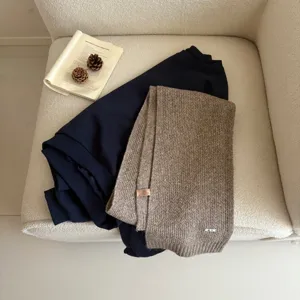 Cosy wool blend knitted winter scarf with delicate texture, stylish and warm accessory.