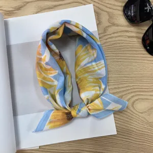 Close-up detail of blue and yellow floral print cotton neck scarf, perfect for summer styling.