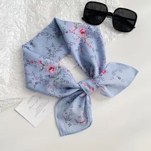 Chic blue floral print silk scarf detail, exquisite botanical pattern design for versatile styling.