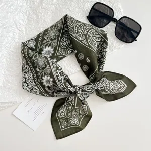 Detailed close-up of the dark green paisley bandana, showing soft fabric texture and patterns.