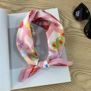 Detailed view of pink patterned cotton bandana scarf, perfect for neckerchief or hair wrap styling.