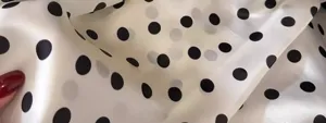 Detailed view of the vintage black and white polka dot silk square scarf for women.