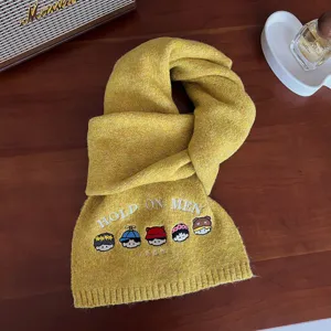 Yellow knitted winter warm wool blend scarf with cute cartoon embroidery and stylish text.
