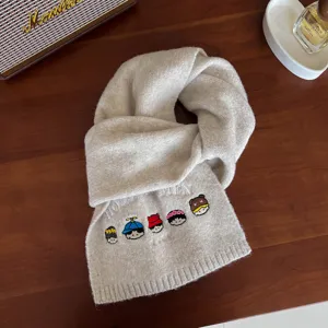 Beige knit scarf with cute embroidered cartoon faces, warm and thick winter accessory for women.