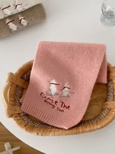 Cute embroidered ski bear knit scarf detail, soft pink winter warm fashion accessory for women.