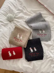 Cozy knit scarf for women featuring cute skiing bear embroidery and stylish winter fashion warmth.