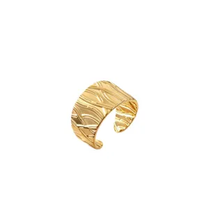 Trendy golden wide open stainless steel textured ring with elegant abstract pattern design.