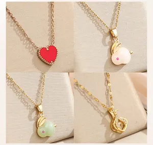 Detailed view of fashion gold-tone stainless steel necklaces featuring delicate heart and animal pendants.