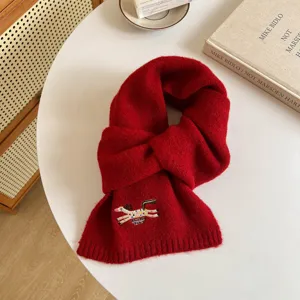 Close-up view of the red wool-blend scarf featuring cute embroidered horse detail and warm knit texture.