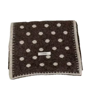 Cozy wool-blend polka dot scarf with stitched edges, stylish and warm winter accessory.