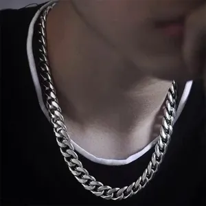 Close-up detail of thick silver cuban chain necklace, shining metallic luster for hip hop style.