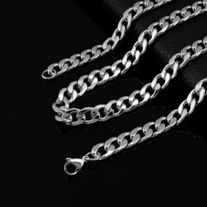 Close-up detail of a thick silver cuban link chain necklace with lobster clasp, durable metal shine.