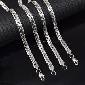 Detailed view of silver titanium steel Cuban chain necklace with embossed NK pattern and secure clasp.