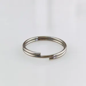 Close-up detail shot of stainless steel double split ring, durable DIY jewelry connecting loop.