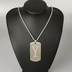 Stainless steel letter pendant necklace detail, silver cutout Y dog tag chain jewelry closeup.