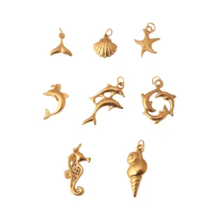 Gold marine pendants set featuring dolphin, starfish, and seashell charms for DIY jewelry making.
