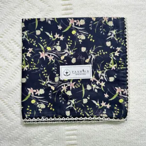 Detailed shot of vintage floral cotton handkerchief with delicate lace edge, soft texture.