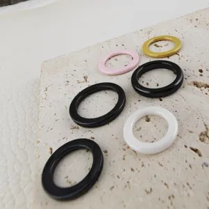 Close up view of colorful zirconia ceramic circle rings, DIY jewelry making accessory details.