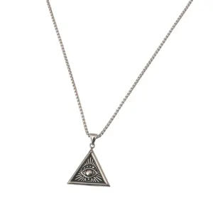 Closeup of the vintage stainless steel eye of providence triangular pendant necklace detail.