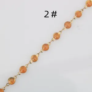 Stainless steel gold-plated chain with orange glitter enamel components for DIY jewelry making.