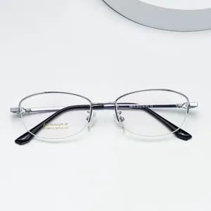 Detail view of women's titanium alloy semi-rimless oval eyeglass frame with flexible temples.