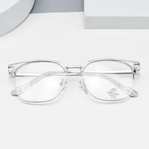 Clear frame glasses detail shot showing transparent optical lens with blue light blocking sticker.