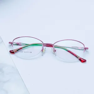 Close-up detail of stylish pink metal semi-rimless eyeglasses frame, elegant and modern.