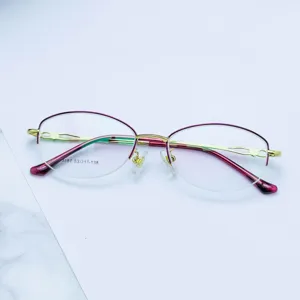 Detailed view of women business metal semi-rimless optical glasses frame in gold.