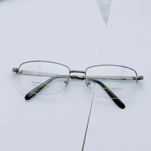 Detailed close-up shot showing the metal half-frame glasses structure and details.