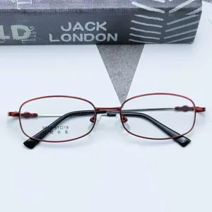 Close-up of red and black metal optical glasses frame detail with memory alloy material.