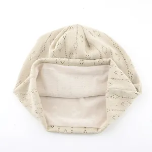 Hollow-out knitted breathable slouchy hat for spring and summer, lightweight postpartum cap detail.