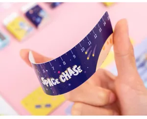 Flexible plastic ruler detail view with cute space chase theme and clear scale numbers.