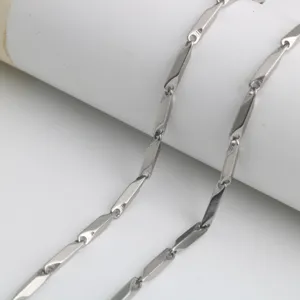 Close-up detail of stainless steel stick chain links, polished silver metallic jewelry accessory.