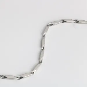 Stainless steel metal chain detail shot, geometric bar link design for jewelry or bag strap.