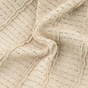 Close-up detail of beige breathable mesh knitted fabric showing soft crinkled texture.