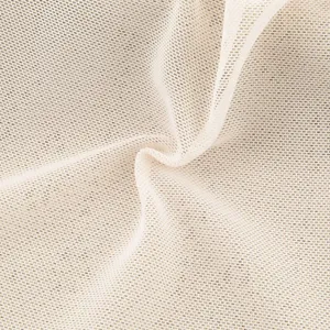 Close-up detail of breathable beige hollow knit fabric showing soft texture and fine mesh weave.