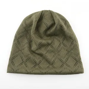 Gros plan d'un bonnet en tricot ajouré vert olive montrant les détails du losange.