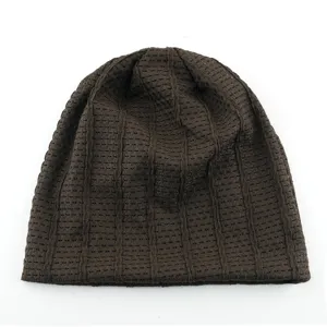 Detailed view of brown mesh knit beanie, breathable summer slouchy hat, casual retro style.