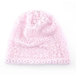Close-up of pink lace slouchy beanie, breathable knit mesh hollow design for women daily style.