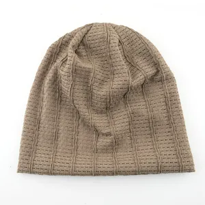 Detail view of the brown mesh knit beanie showcasing its breathable texture and slouchy style.