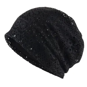 Close-up detail of the black crochet slouchy beanie, showing breathable mesh texture.