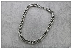 detail view of a wide stainless steel cuban chain necklace for men, hip hop style jewelry