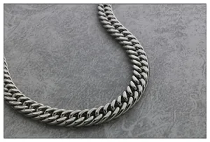 Detail shot of heavy titanium steel men's curb chain necklace, hip hop punk jewelry style.